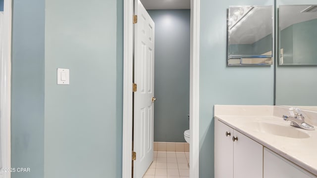 bathroom featuring toilet, vanity, and tile patterned flooring