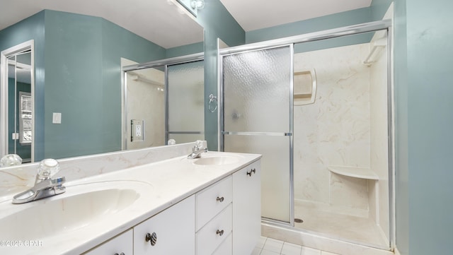 bathroom featuring vanity, tile patterned flooring, and walk in shower