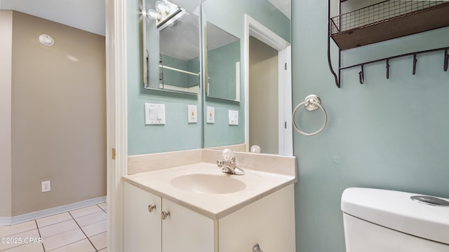 bathroom with tile patterned floors, vanity, and toilet