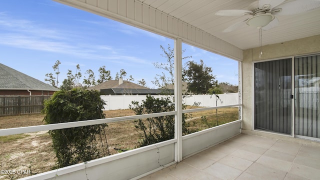 unfurnished sunroom featuring ceiling fan