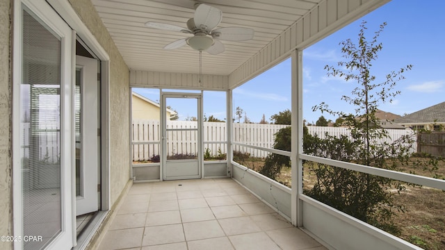 unfurnished sunroom with ceiling fan