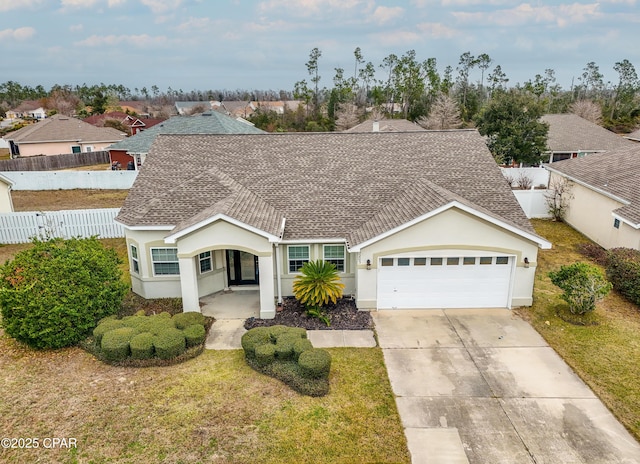 single story home featuring a front lawn and a garage