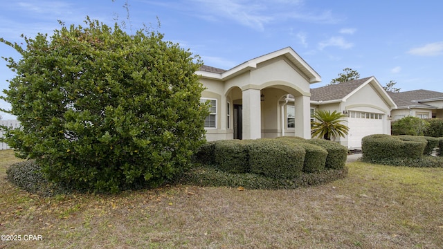 view of property hidden behind natural elements featuring a garage