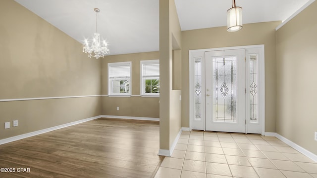 foyer featuring light tile patterned floors and a chandelier