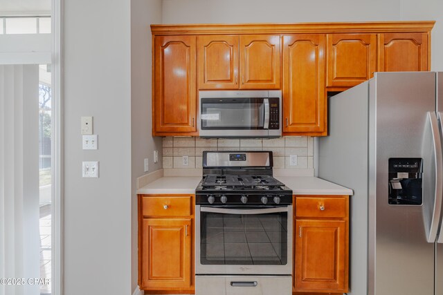 kitchen with tasteful backsplash and stainless steel appliances