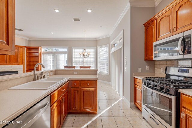 kitchen featuring pendant lighting, sink, dishwasher, an inviting chandelier, and kitchen peninsula