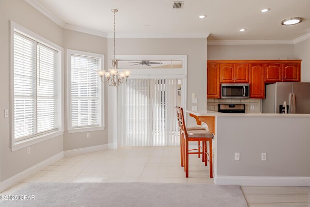 kitchen with stainless steel appliances, a kitchen breakfast bar, kitchen peninsula, and light tile patterned floors