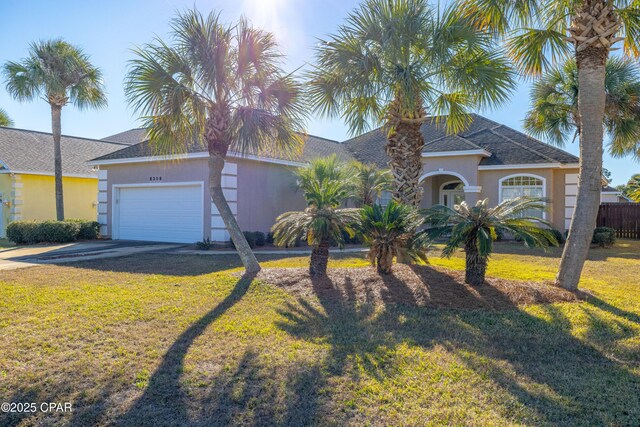 ranch-style house featuring a garage and a front lawn