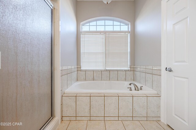 bathroom with tile patterned flooring and separate shower and tub