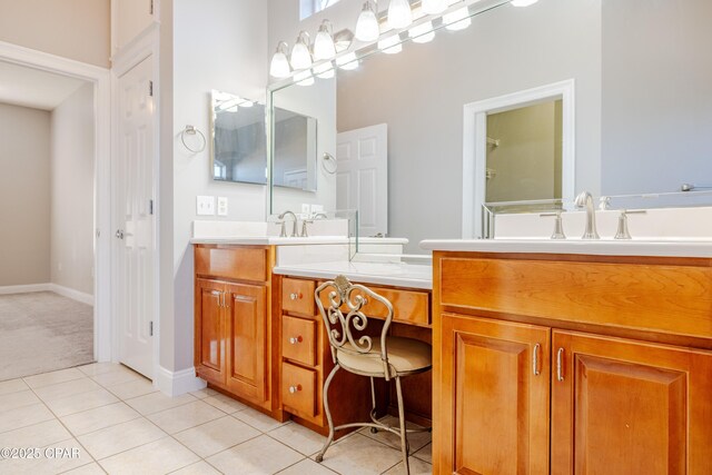 bathroom featuring a shower with door, vanity, and tile patterned floors