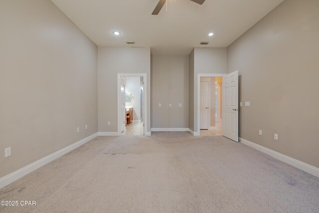 empty room featuring light colored carpet and ceiling fan