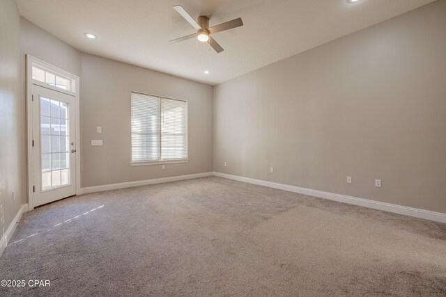 carpeted spare room with ceiling fan