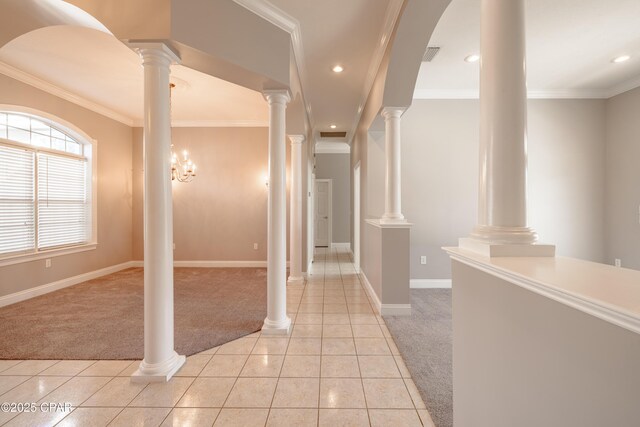 hallway with crown molding, light carpet, and ornate columns