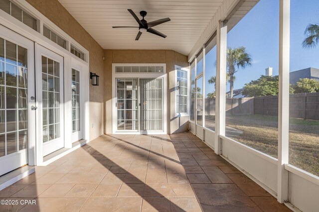 unfurnished sunroom with french doors and ceiling fan