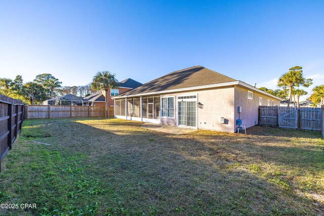 rear view of house featuring a yard