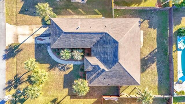 rear view of house featuring a sunroom and a yard