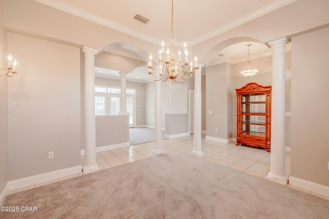 unfurnished room with ornamental molding, decorative columns, and light carpet