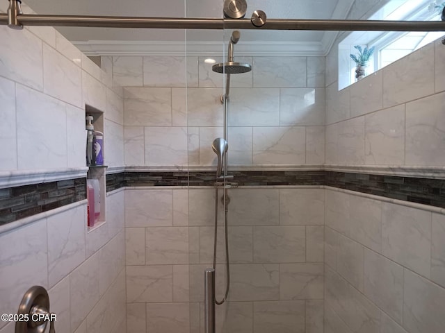 bathroom with an enclosed shower and ornamental molding