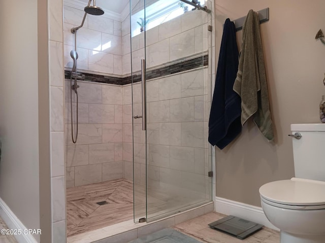 bathroom with an enclosed shower and toilet