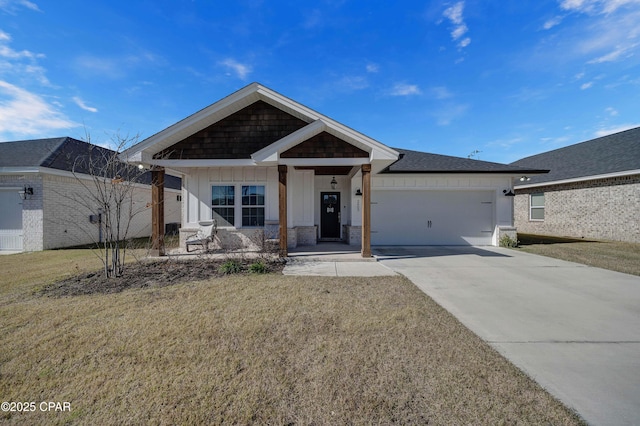 view of front of house featuring a garage, a front yard, and a porch