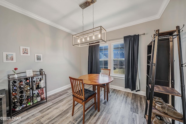 dining room featuring crown molding and wood-type flooring