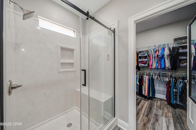 bathroom featuring walk in shower and hardwood / wood-style flooring