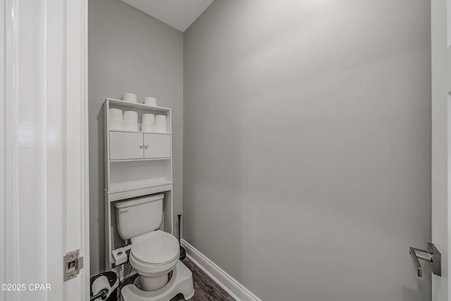 bathroom featuring toilet and wood-type flooring