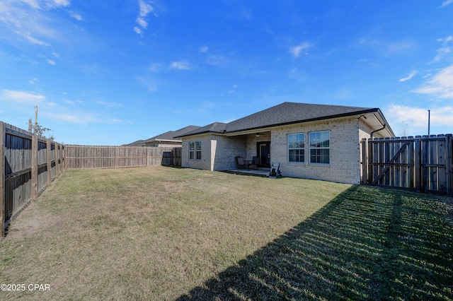 rear view of house featuring a yard