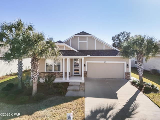 view of front facade featuring a front yard, a porch, a garage, and central AC unit