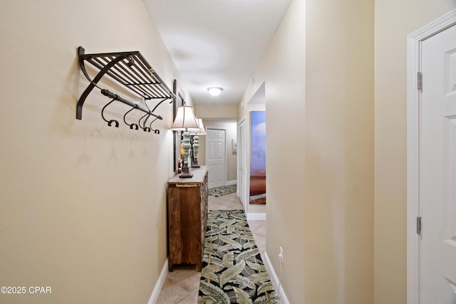 hall with light tile patterned floors