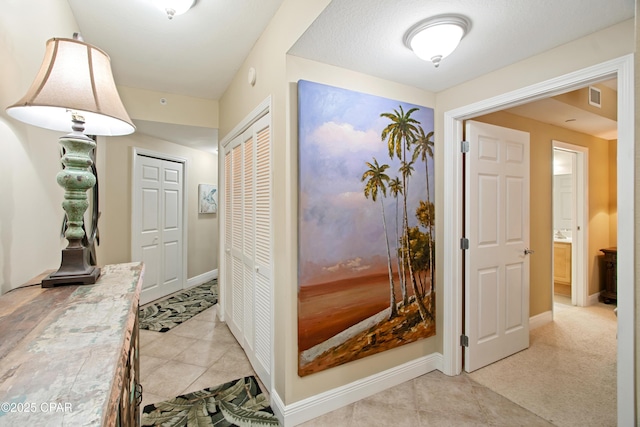 hallway featuring light tile patterned floors