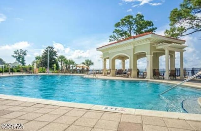 view of swimming pool with a patio