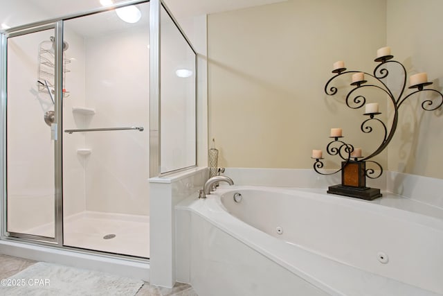 bathroom featuring shower with separate bathtub