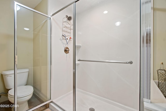 bathroom featuring an enclosed shower and toilet