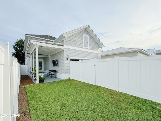 back of house with a yard and a patio area