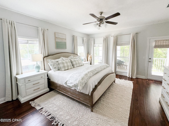 bedroom featuring hardwood / wood-style flooring, ceiling fan, multiple windows, and access to outside