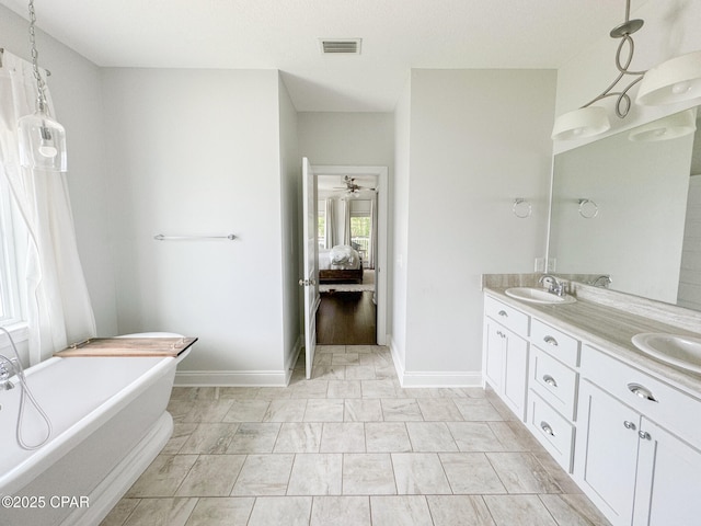 bathroom with vanity, a washtub, and ceiling fan