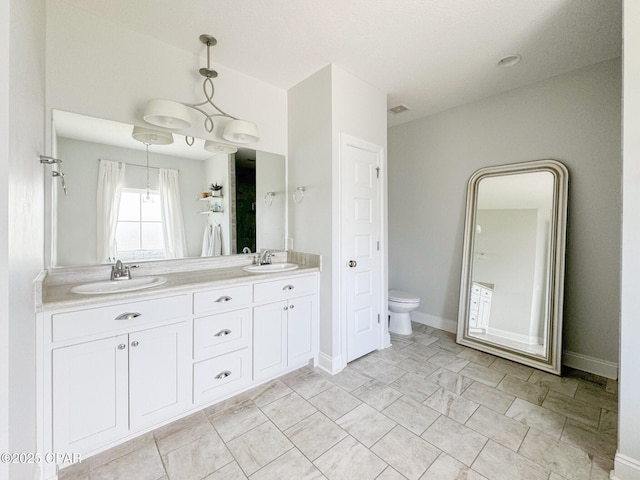 bathroom featuring vanity and toilet