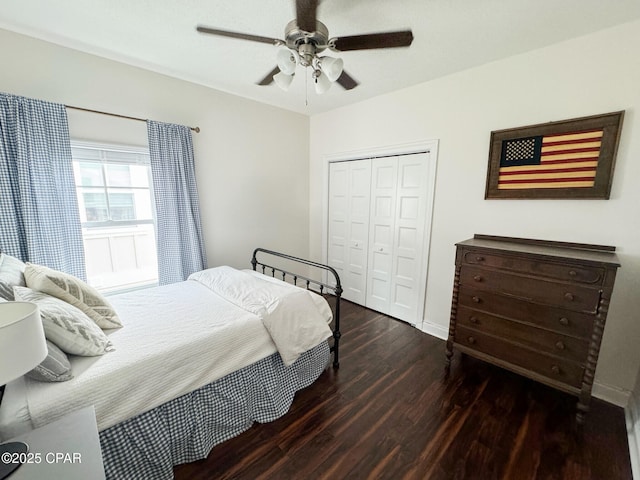 bedroom featuring ceiling fan, dark hardwood / wood-style flooring, and a closet