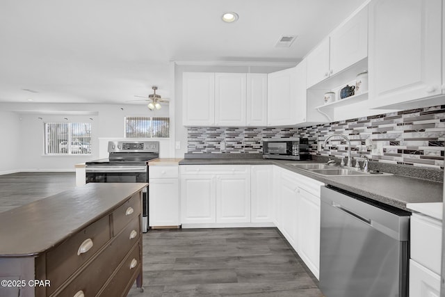 kitchen with ceiling fan, sink, dark hardwood / wood-style floors, white cabinets, and appliances with stainless steel finishes