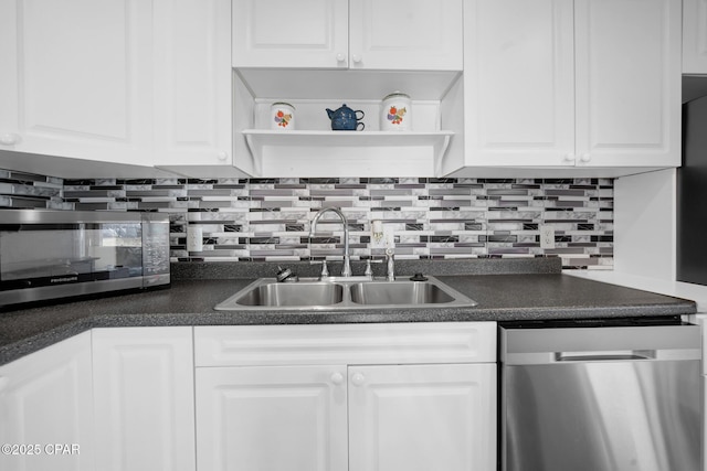 kitchen featuring backsplash, white cabinetry, sink, and stainless steel appliances