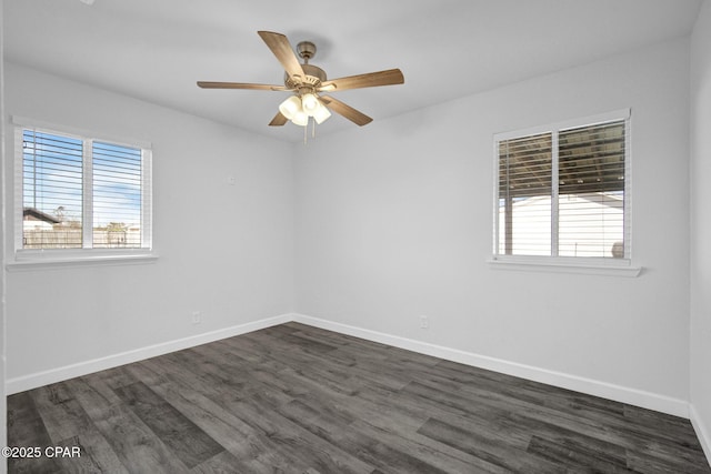 spare room with ceiling fan, dark wood-type flooring, and a wealth of natural light