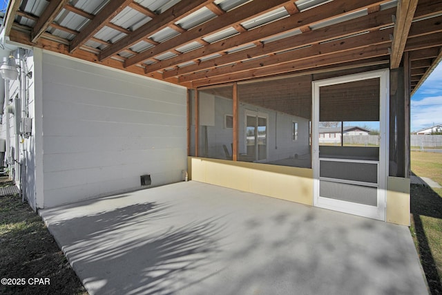 view of patio with a sunroom