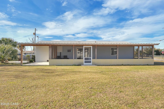 back of house featuring a sunroom and a yard