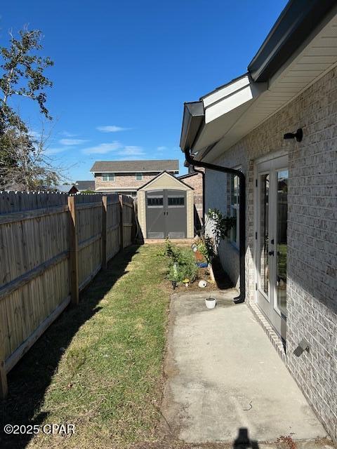 view of yard featuring french doors and a shed