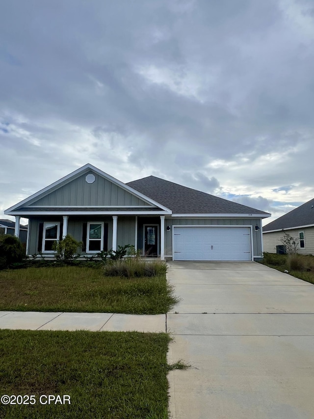 ranch-style home featuring a garage and a front lawn