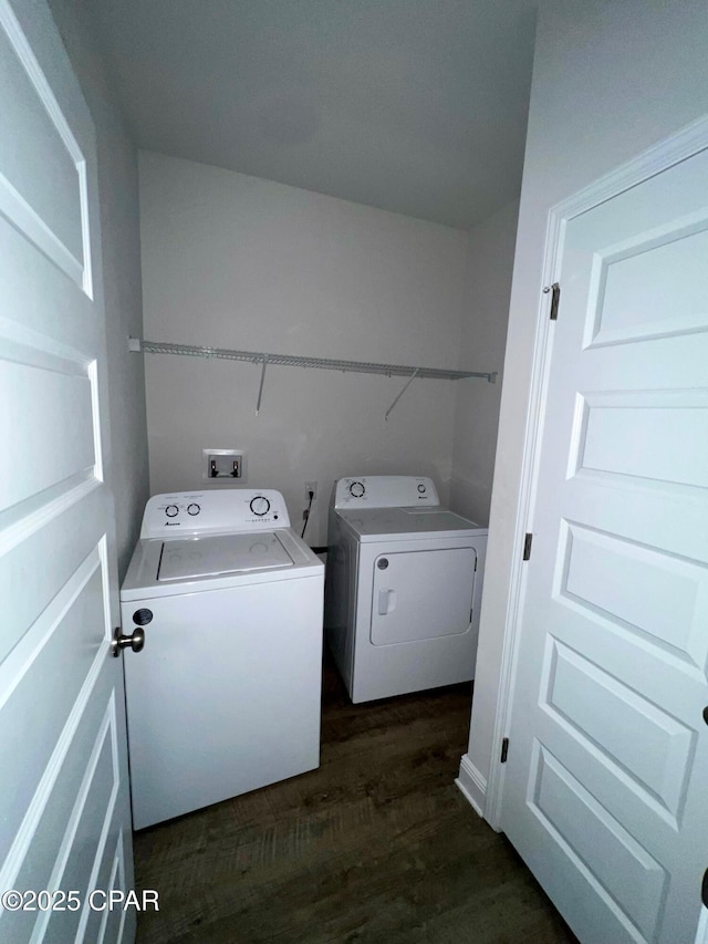 laundry room featuring washer and dryer and dark hardwood / wood-style flooring