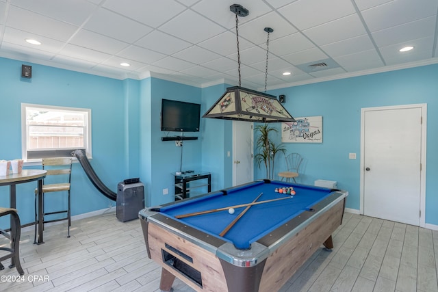 recreation room featuring a paneled ceiling, ornamental molding, pool table, and light hardwood / wood-style flooring