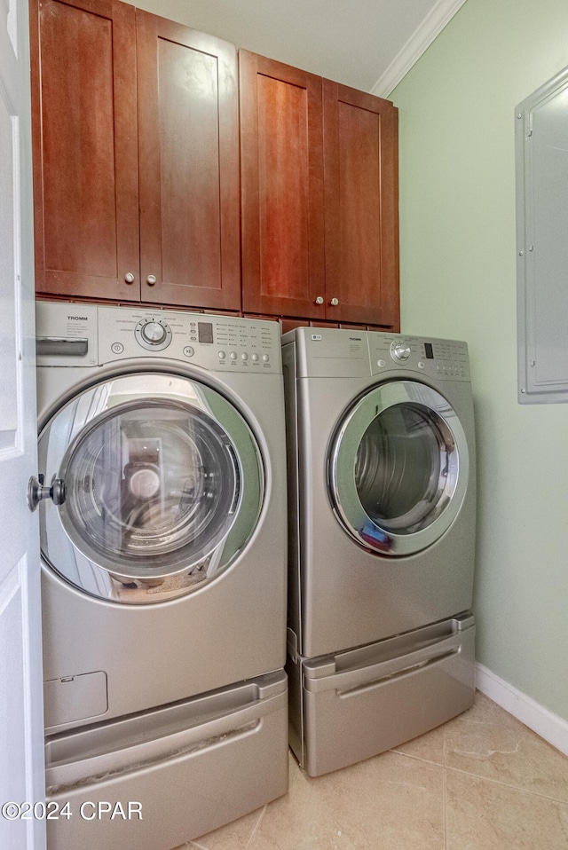 clothes washing area with cabinets, ornamental molding, light tile patterned floors, and washer and clothes dryer