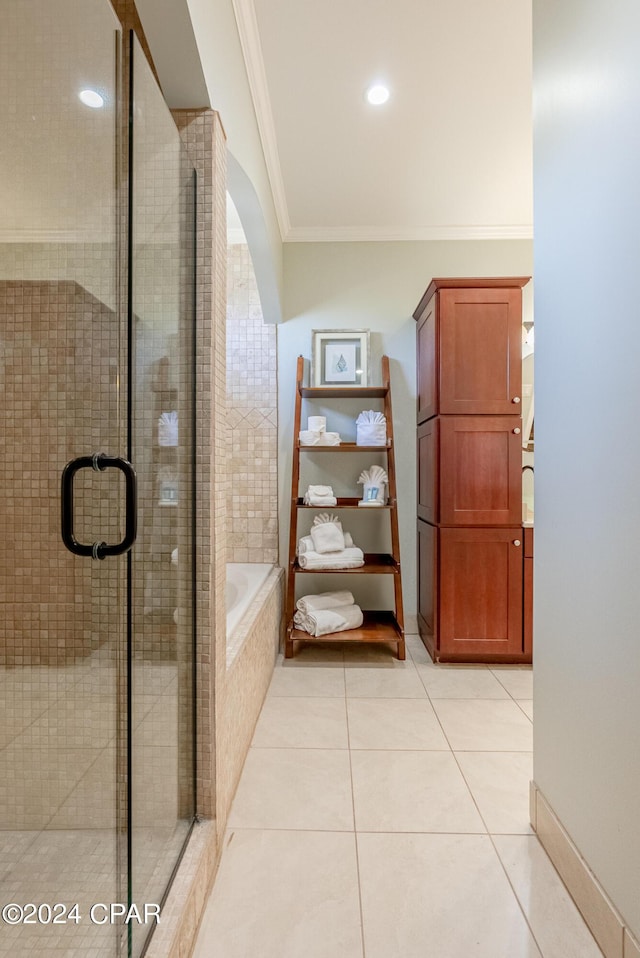 bathroom featuring tile patterned floors, ornamental molding, and separate shower and tub